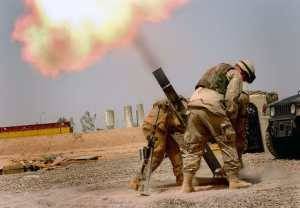 US soldiers in Iraq fire a 120mm mortar.