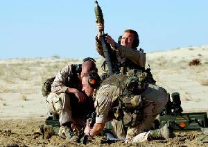 U.S. soldiers prepare to fire a mortar round