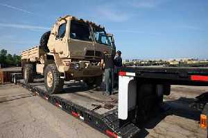Oshkosh Defense FMTV trucks and trailers leave the companys Oshkosh, Wis., campus for delivery ahead of schedule to the U.S. A